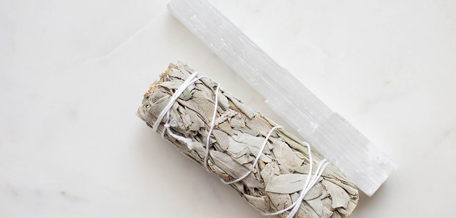 crystal wand and sage on light countertop