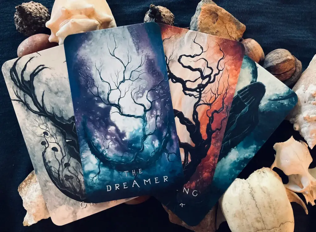 Dreams & Incarnations Oracle Deck four cards laid out on shells