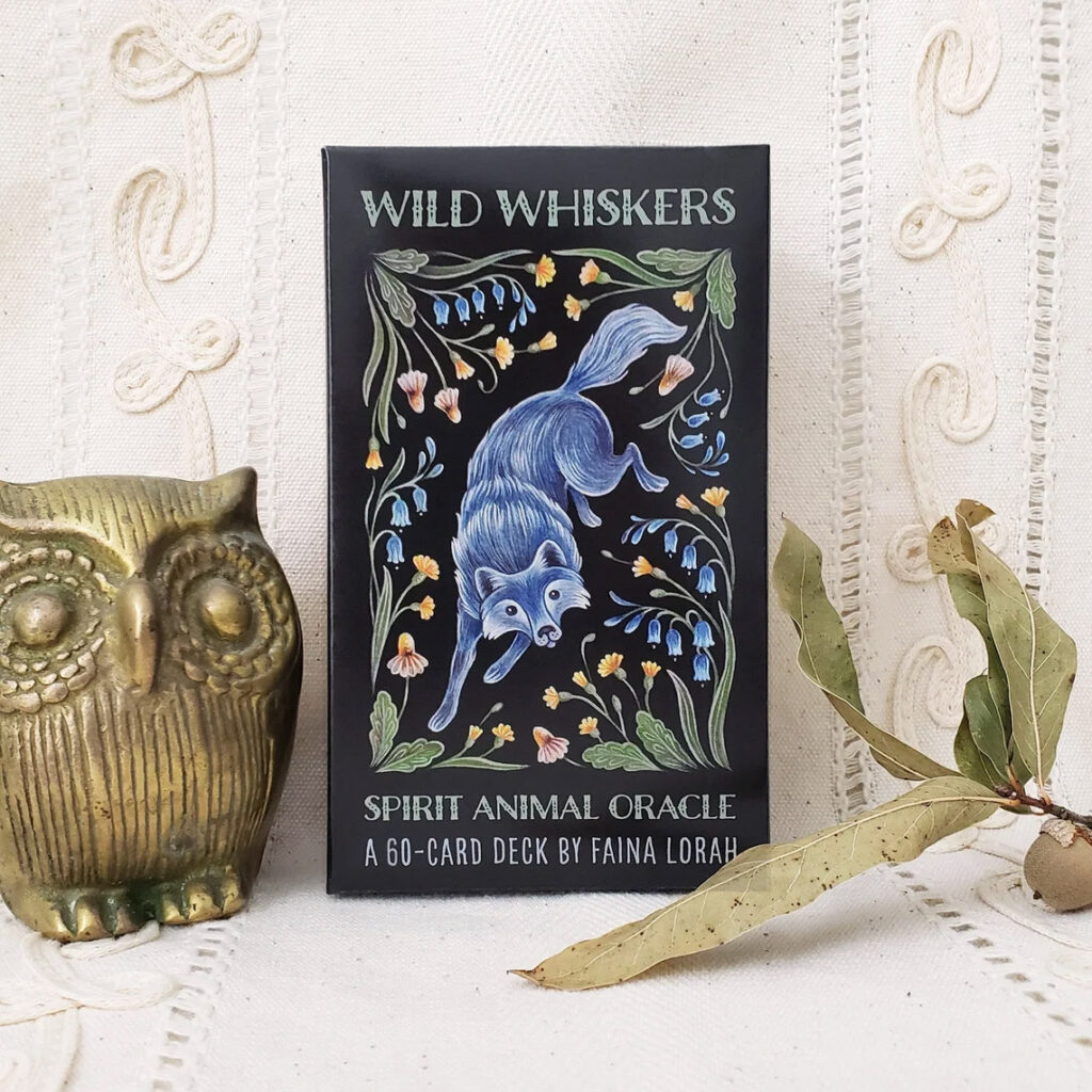 Wild Whiskers Oracle Deck with Owl Statue next to it