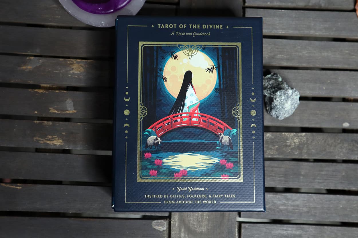 Tarot of the divine oracle deck box on wood table