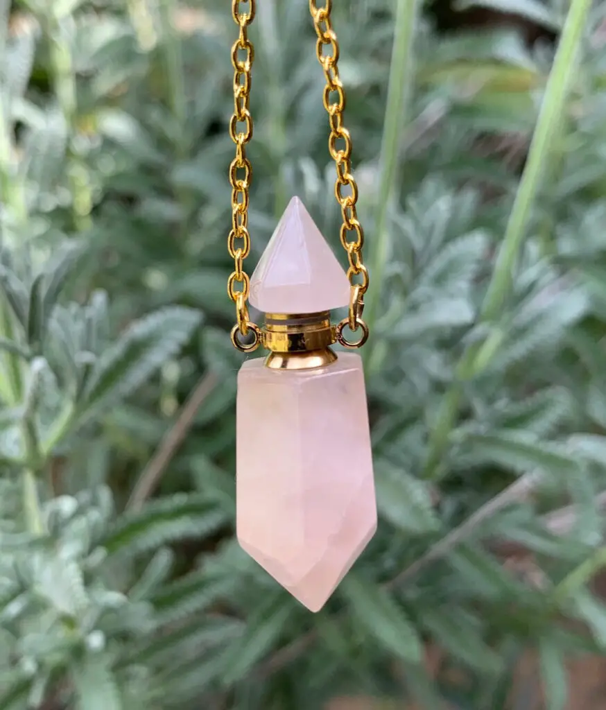 Rose Quartz Necklace Hanging with Plant Background